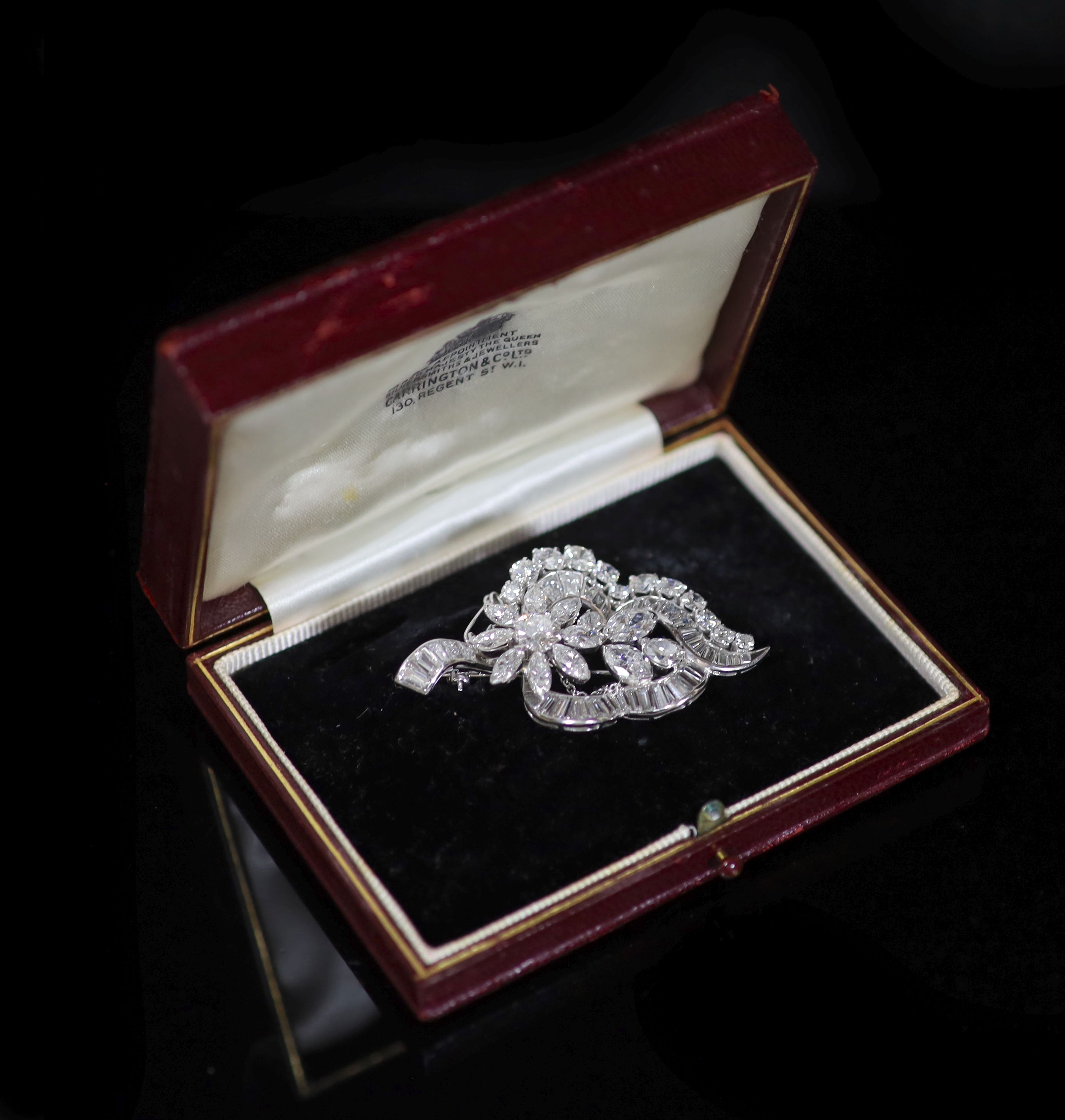 A 1960's white gold and diamond flower design brooch,